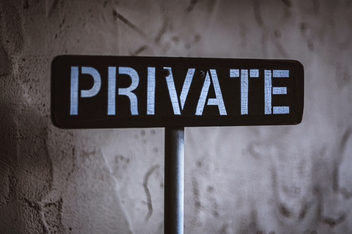 black-and-white-wooden-sign-behind-white-concrete-3690735