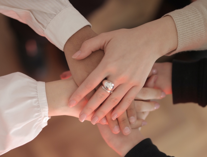 crop-friends-stacking-hands-together-3830752